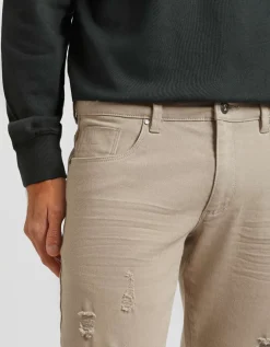 Pantaloni cinque tasche in cotone con strappi